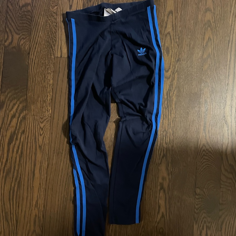 Navy adidas leggings with bright blue stripe.